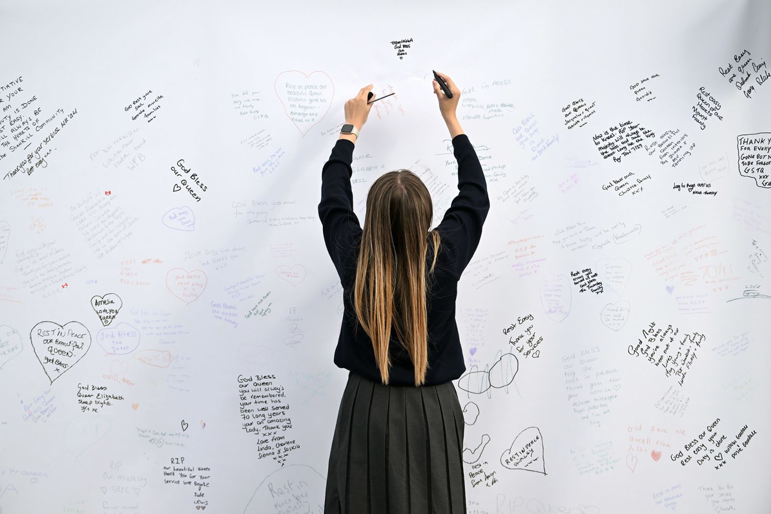 Condolence messages are written on a wall in Belfast, Northern Ireland.