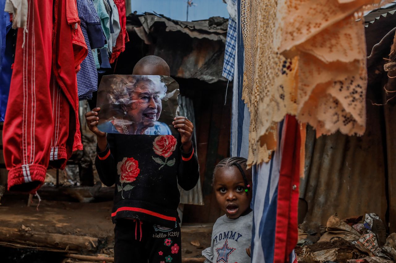 A young girl in Nairobi, Kenya, holds an image of the Queen on Friday.