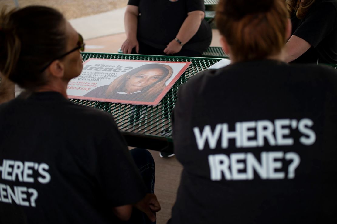Women helping search for Irene Gakwa post signs seeking information on June 18 in Gillette, Wyoming.