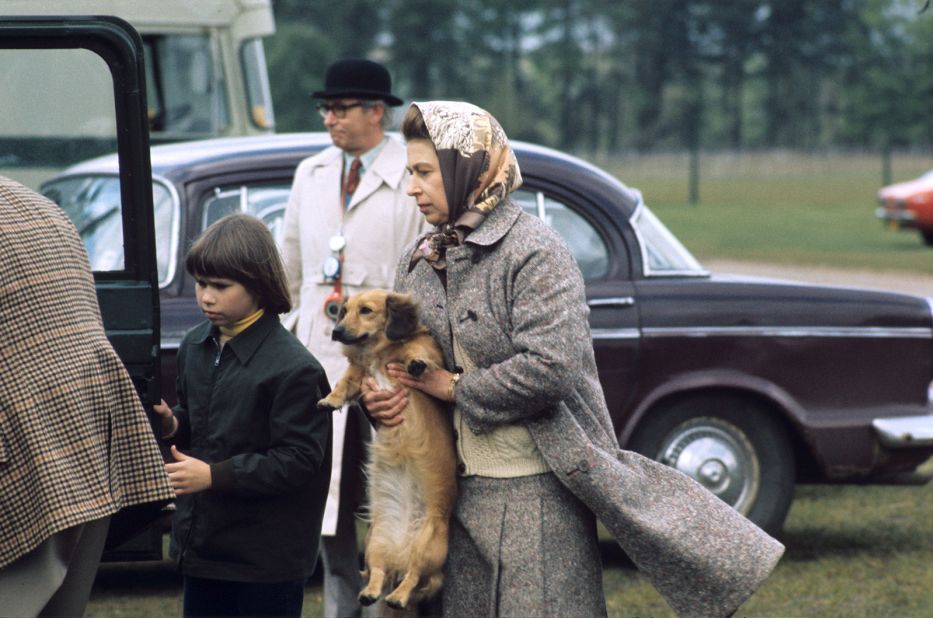 The Queen holds one of her "dorgis," a cross between a corgi and a dachshund, in 1960. She is credited with creating the breed after her corgi mated with a dachshund owned by her sister, Princess Margaret. 