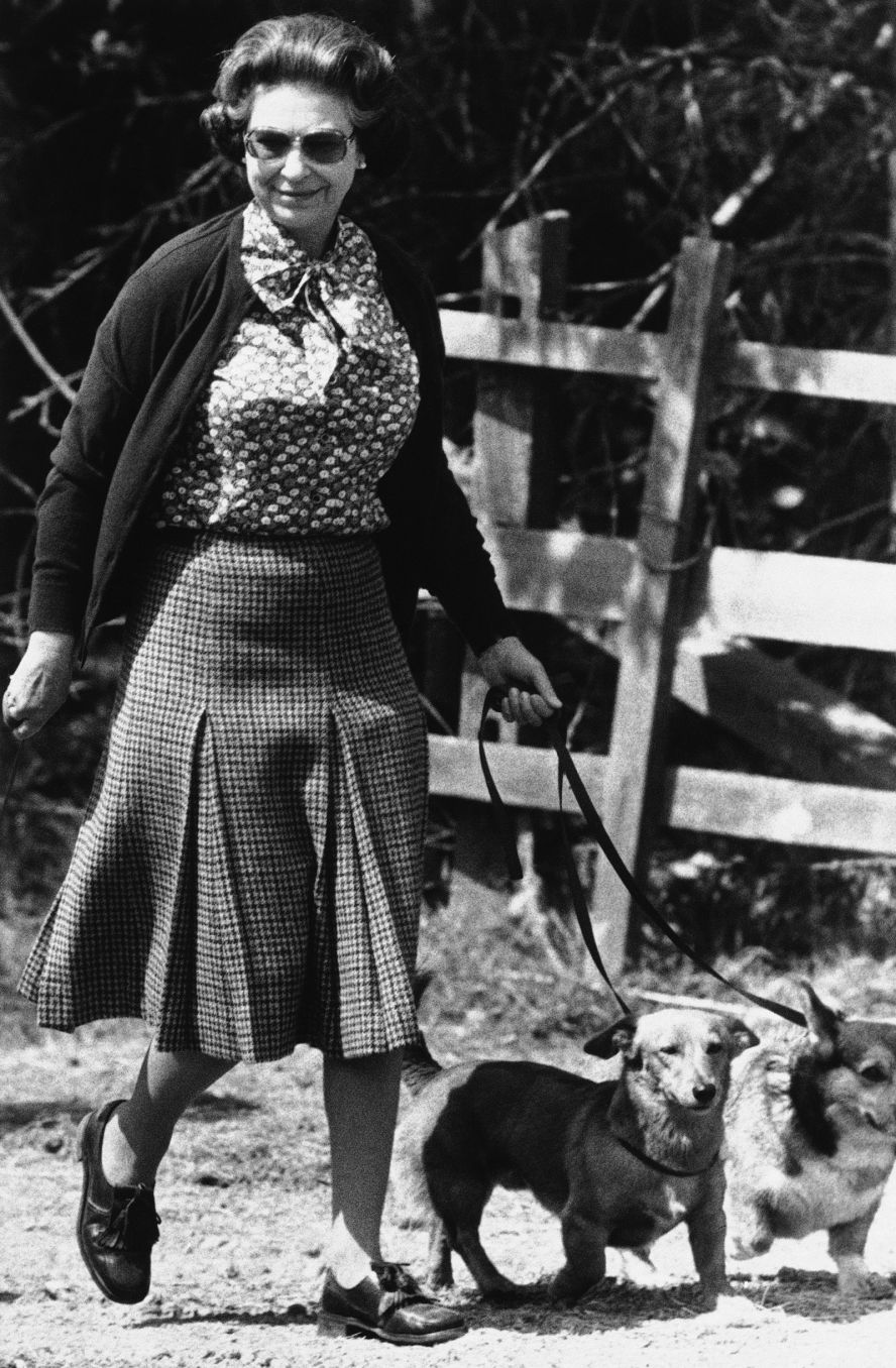 The Queen and some of her corgis walk during the second day of the Windsor Horse Trials in 1980.
