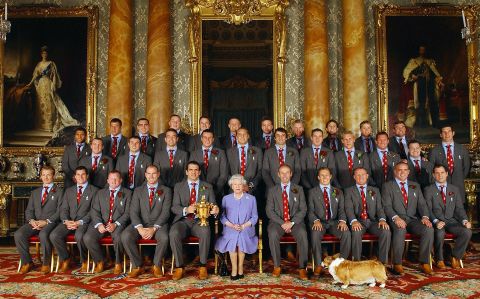 One of the Queen's corgis gets into a photo with the Queen and England's World Cup-winning rugby team in 2003.