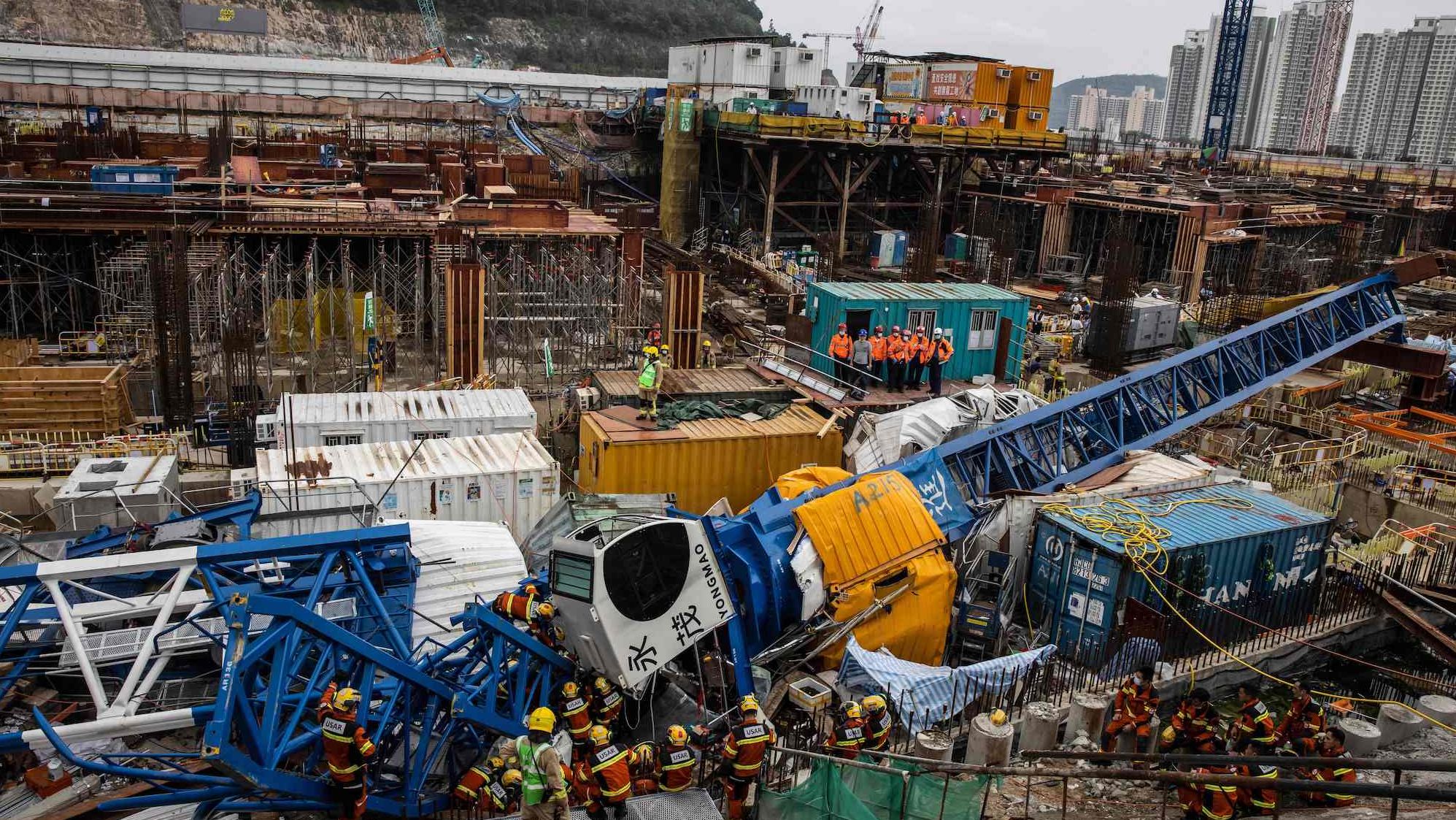 A search-and-rescue team works at the site of a collapsed crane in Hong Kong on Wednesday, September 7. At least two people were killed, and more were injured.