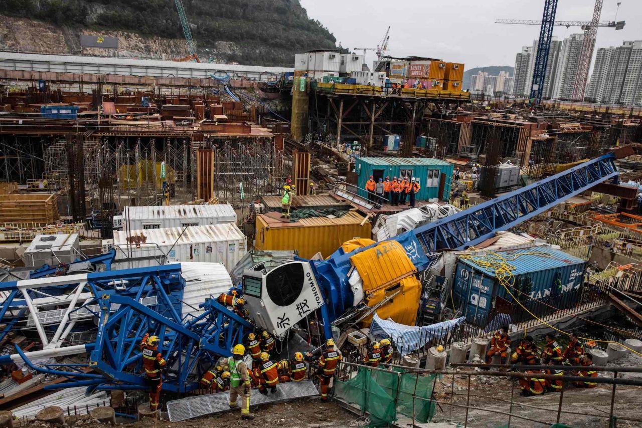 A search-and-rescue team works at the site of a collapsed crane in Hong Kong on Wednesday, September 7. At least two people were killed, and more were injured.