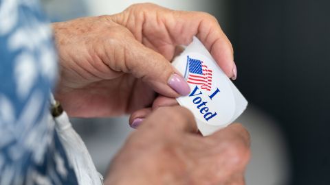 A poll worker holds a sticker that reads, I Voted on May 17, 2022 in Mt. Gilead, North Carolina. 