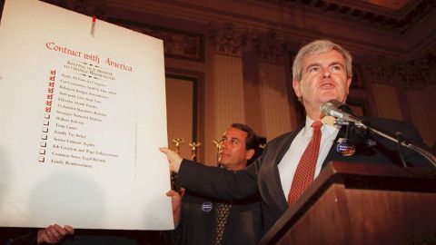Speaker of the US House of Representatives Newt Gingrich(R-GA), holds up a copy of the  "Contract With America" during a rally to celebrate the first 50 days of the Republican majority in Congress in 1995.