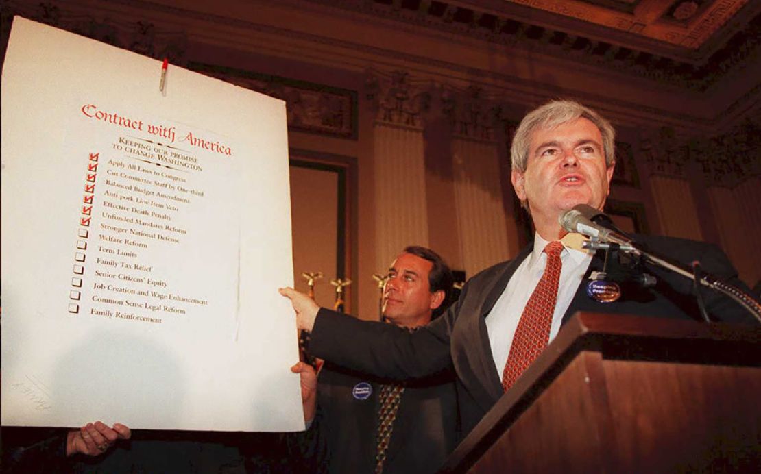 Speaker of the US House of Representatives Newt Gingrich(R-GA), holds up a copy of the  "Contract With America" during a rally to celebrate the first 50 days of the Republican majority in Congress in 1995.