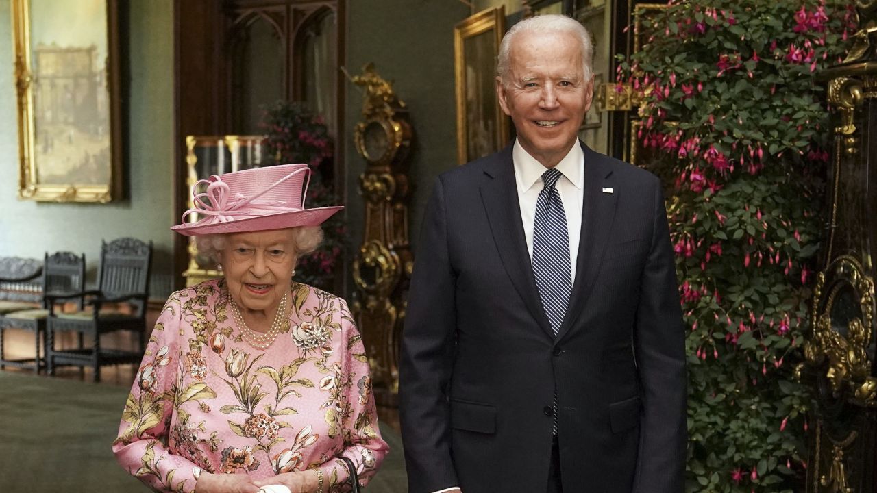 WINDSOR, ENGLAND - JUNE 13: Queen Elizabeth II with US President Joe Biden in the Grand Corridor during their visit to Windsor Castle on June 13, 2021 in Windsor, England. Queen Elizabeth II hosts US President, Joe Biden and First Lady Dr Jill Biden at Windsor Castle. The President arrived from Cornwall where he attended the G7 Leader's Summit and will travel on to Brussels for a meeting of NATO Allies and later in the week he will meet President of Russia, Vladimir Putin. (Photo by Steve Parsons - WPA Pool/Getty Images)