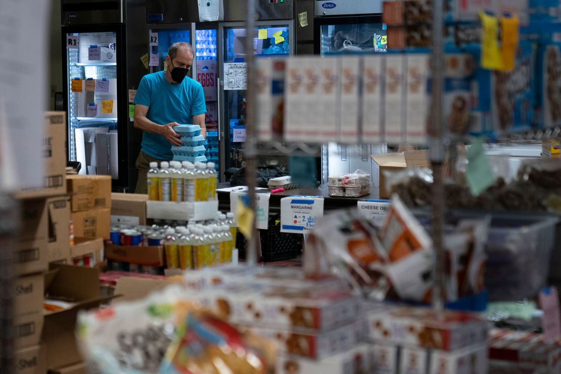 A volunteer organizes groceries at a pantry in the basement of Calvary Lutheran Church, which is set to be converted into affordable housing.