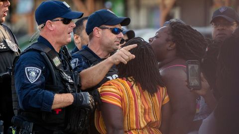 Brittany Martin, center, wearing striped clothing, confronts police as demonstrators in support of George Floyd march with an escort around downtown Sumter, SC, on May 31, 2020. 