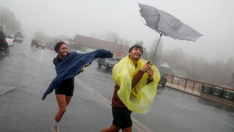 Carlos and Jaira Mierta walking on a windy and rainy Thursday in Julian, California.