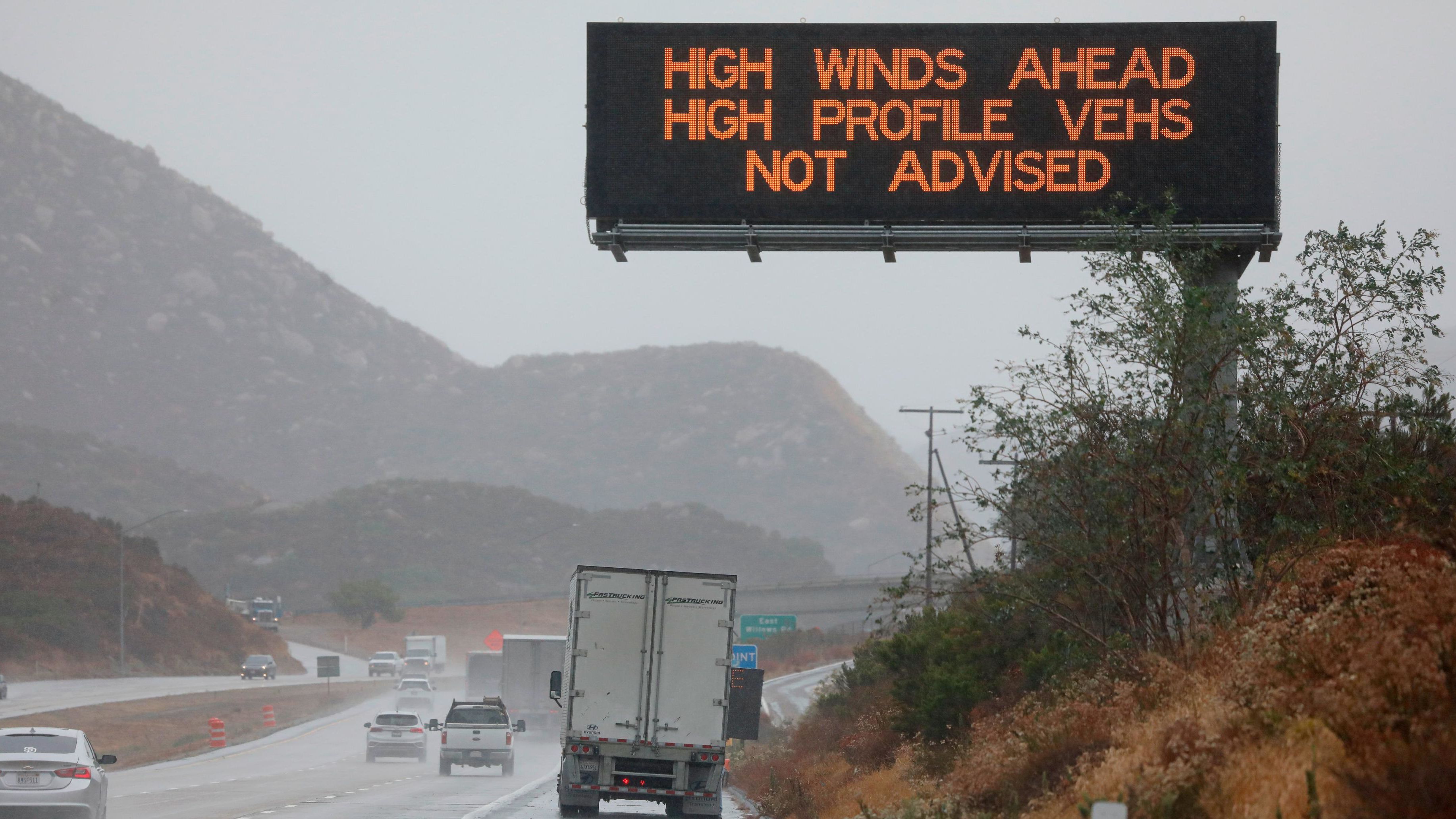 A travel advisory sign is posted for high winds on Interstate 8, East of San Diego, on Thursday in Julian, California.  