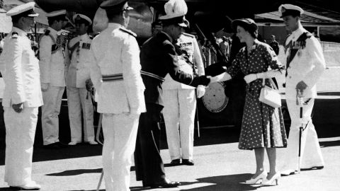 Elizabeth, then a princess, and Prince Philip exit their plane in Nairobi, Kenya, on the first leg of their Commonwealth tour in 1952.