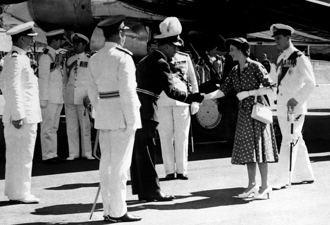 Elizabeth, then a princess, and Prince Philip step from their plane in Nairobi, Kenya, on the first stage of their Commonwealth tour in 1952.