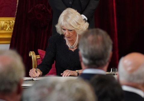 Camilla signs an oath during Saturday's meeting of the Accession Council.