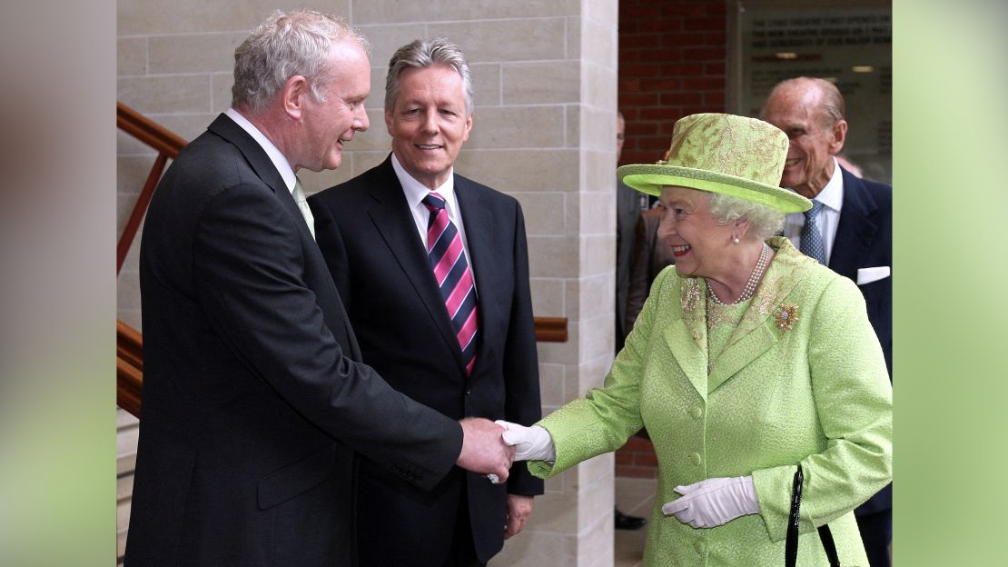 Queen Elizabeth II shakes hands with Northern Ireland Deputy First Minister Martin McGuinness, left, watched by First Minister Peter Robinson and Prince Philip at the Lyric Theatre in Belfast, Northern Ireland, on June 27, 2012.