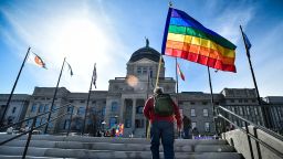 In this March 15, 2021, file photo, demonstrators gather on the steps of the Montana State Capitol protesting anti-LGBTQ+ legislation in Helena, Mont. Two transgender people sued Friday, July 16, 2021, over a new Montana law that makes it difficult for transgender people to change the sex on their birth certificates. 