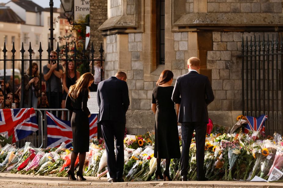 From left, Catherine, Prince William, Prince Harry and Meghan look at floral tributes outside Windsor Castle on September 10.