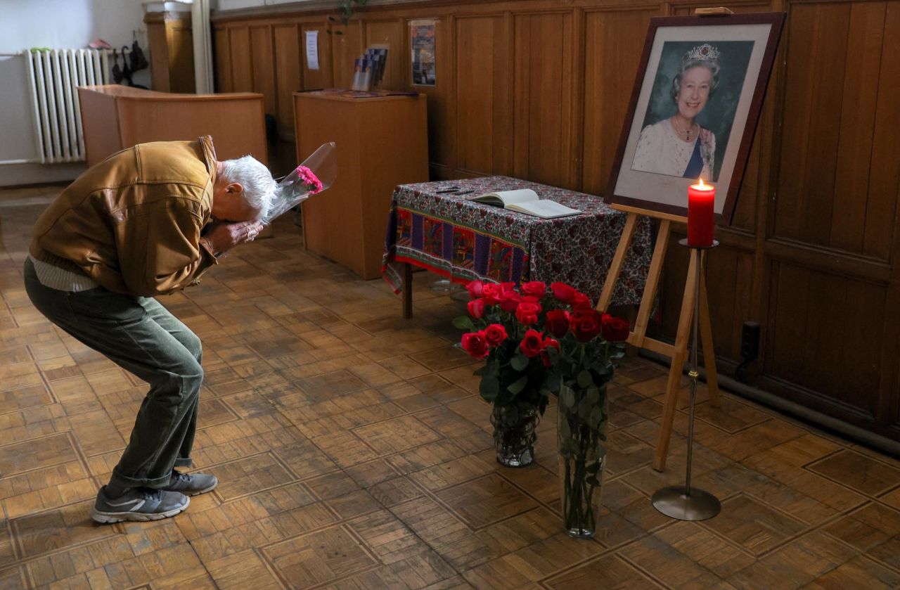 A mourner in Moscow prays in front of a portrait of the Queen as people visit the Anglican Church of St. Andrew on Friday.