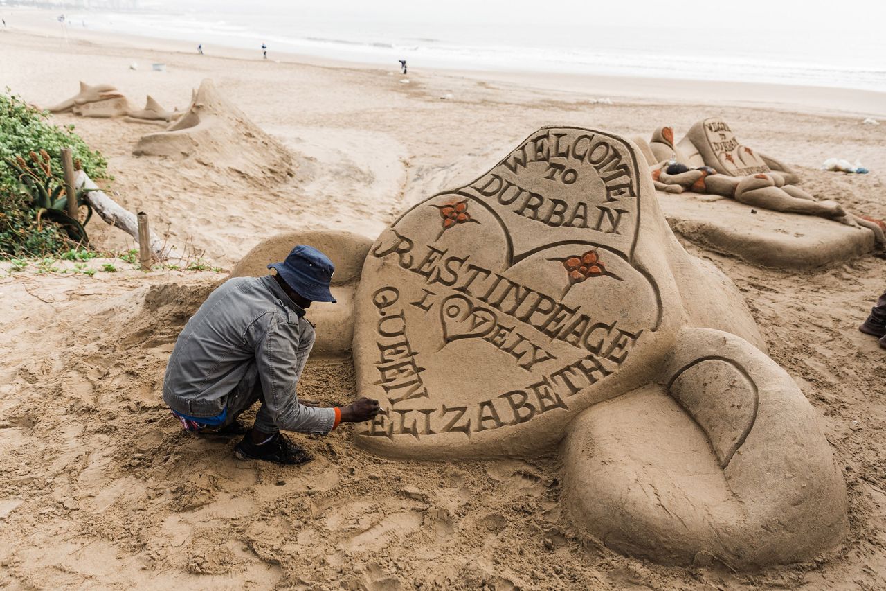 A sand sculptor in Durban, South Africa, puts the final touches on a tribute on Friday.