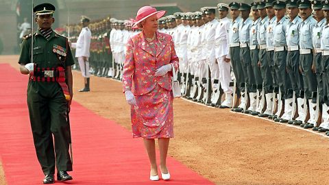 Britain's Queen Elizabeth II inspects a guard of honor at the Presidential palace in New Delhi during her visit to India in 1997. 