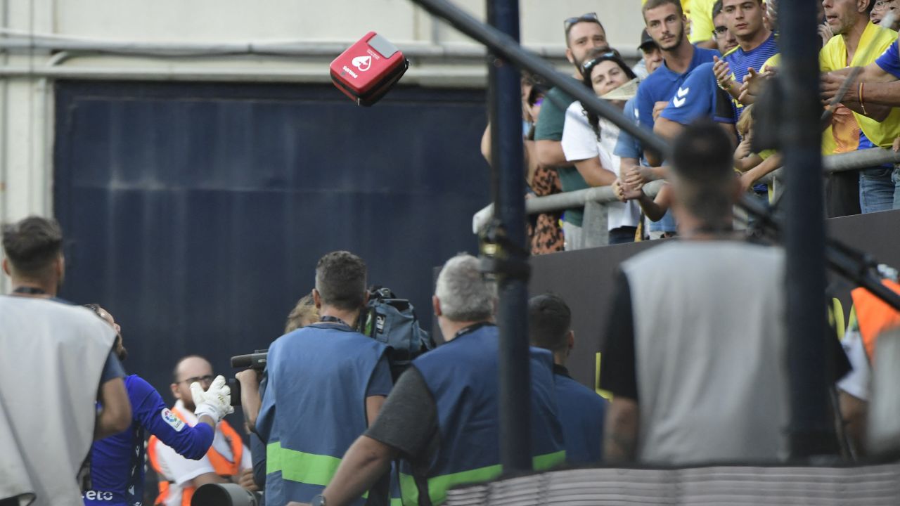Cadiz goalkeeper Jeremias Ledesma (bottom left) throws medical equipment towards the tribunes. 
