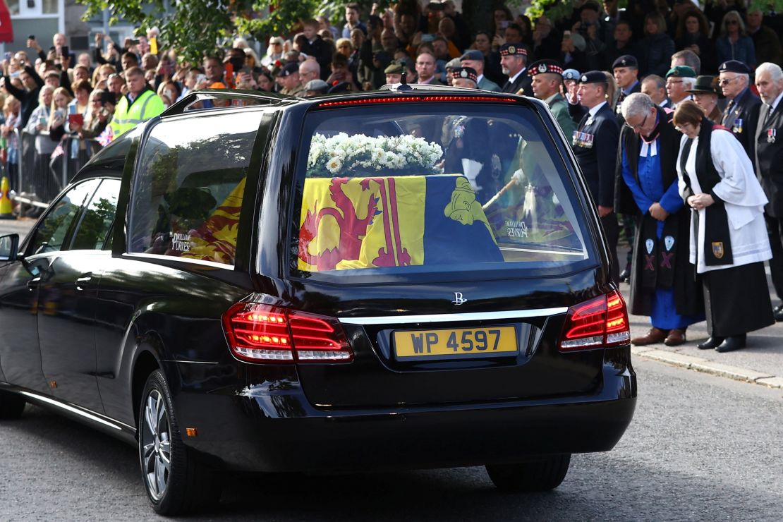 People lined the street as the hearse carrying the Queen's coffin passed through the Scottish village of Ballater.