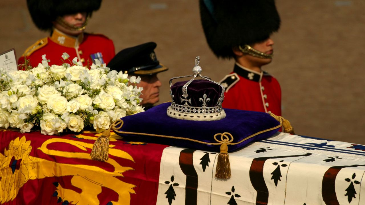 403363 02: A diamond-encrusted crown bearing the Koh-I-Noor Diamond lies on a coffin bearing the Queen Mother April 5, 2002 as her ceremonial procession makes its way down The Mall in London. The Queen Mother's body will lie in state in Westminster Hall before her funeral in four days. (Photo by Sion Touhig/Getty Images)