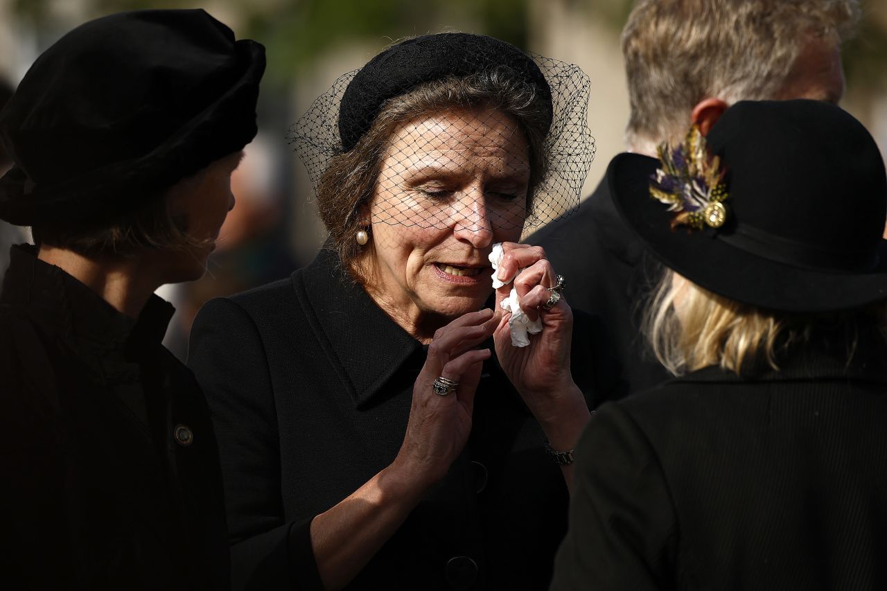 A woman looks emotional as people gather in Ballater, Scotland, to watch the procession on September 11. Thousands lined the route of the royal cortege that passed through the Scottish countryside and the cities of Aberdeen and Dundee.