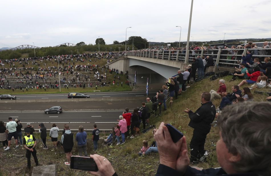 People watch the procession after the hearse traveled over the Queensferry Bridge.