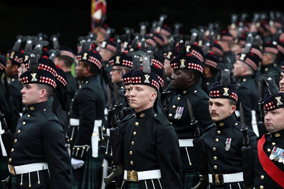 An honor guard stands in position before the arrival of the Queen's coffin at the Palace of Holyroodhouse.