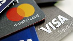 Visa Inc. and Mastercard Inc. credit cards are arranged for a photograph in Tiskilwa, Illinois, U.S., on Tuesday, Sept. 18, 2018. Visa and Mastercard agreed to pay as much as $6.2 billion to end a long-running price-fixing case brought by merchants over card fees, the largest-ever class action settlement of an antitrust case. Photographer: Daniel Acker/Bloomberg via Getty Images