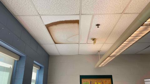 A browning ceiling tile hangs over a room this school year at Joseph G. Pyne Arts Magnet School in Lowell, Massachusetts.