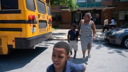 Latoya Carroll, picks up her children, Xavier Braxton, 8, and Jayden Braxton, 7, during the early dismissal at Franklin Square Elementary/Middle School due to lack of air conditioning in the school building and high temperatures, Tuesday, May 31, 2022, in Baltimore, Md, (Vincent Alban/The Baltimore Sun via AP)
