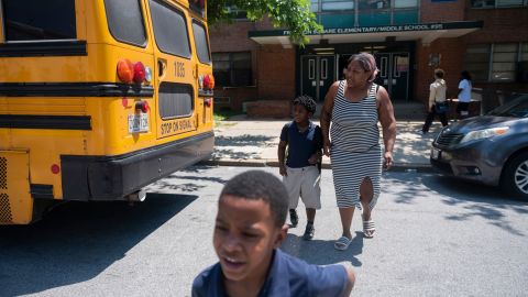 Latoya Carroll picks up her children from early dismissal at Baltimore's Franklin Square Elementary/Middle School in May due to a lack of air conditioning.