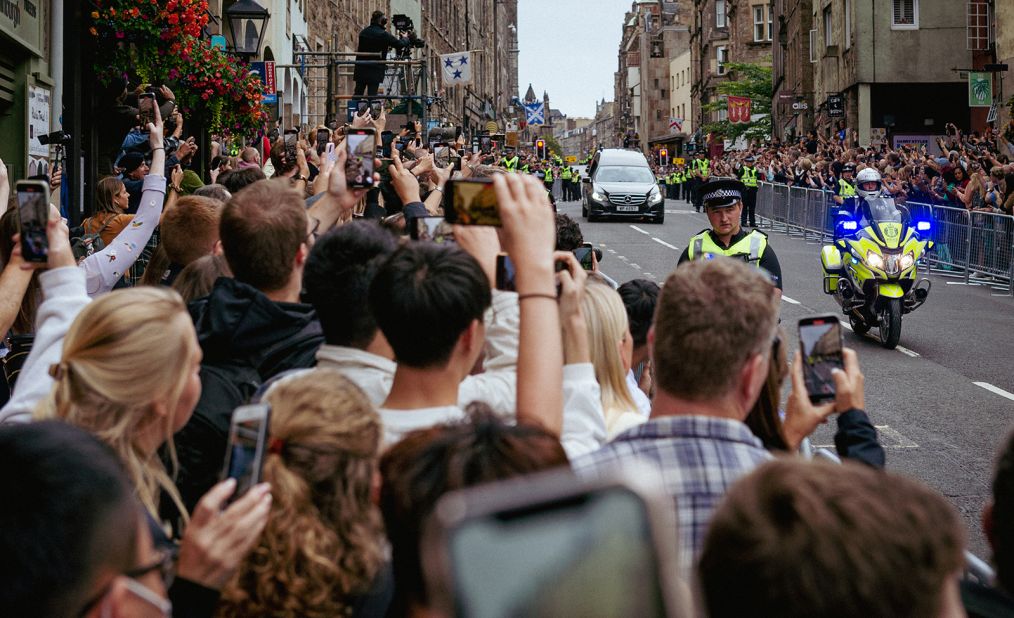 Crowds watch the hearse carrying the Queen's coffin as it makes its way down the Royal Mile in Edinburgh.