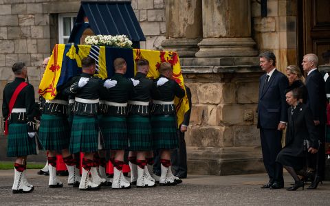 Princess Anne curtseys as her mother's coffin enters the Palace of Holyroodhouse.