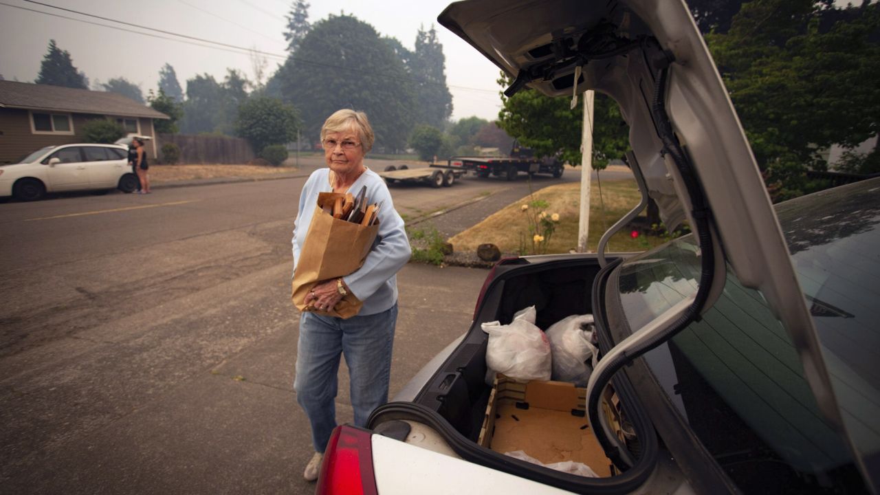 Oakridge, Oregon, resident Patty Beard loads photographs into her car while preparing to evacuate Friday.