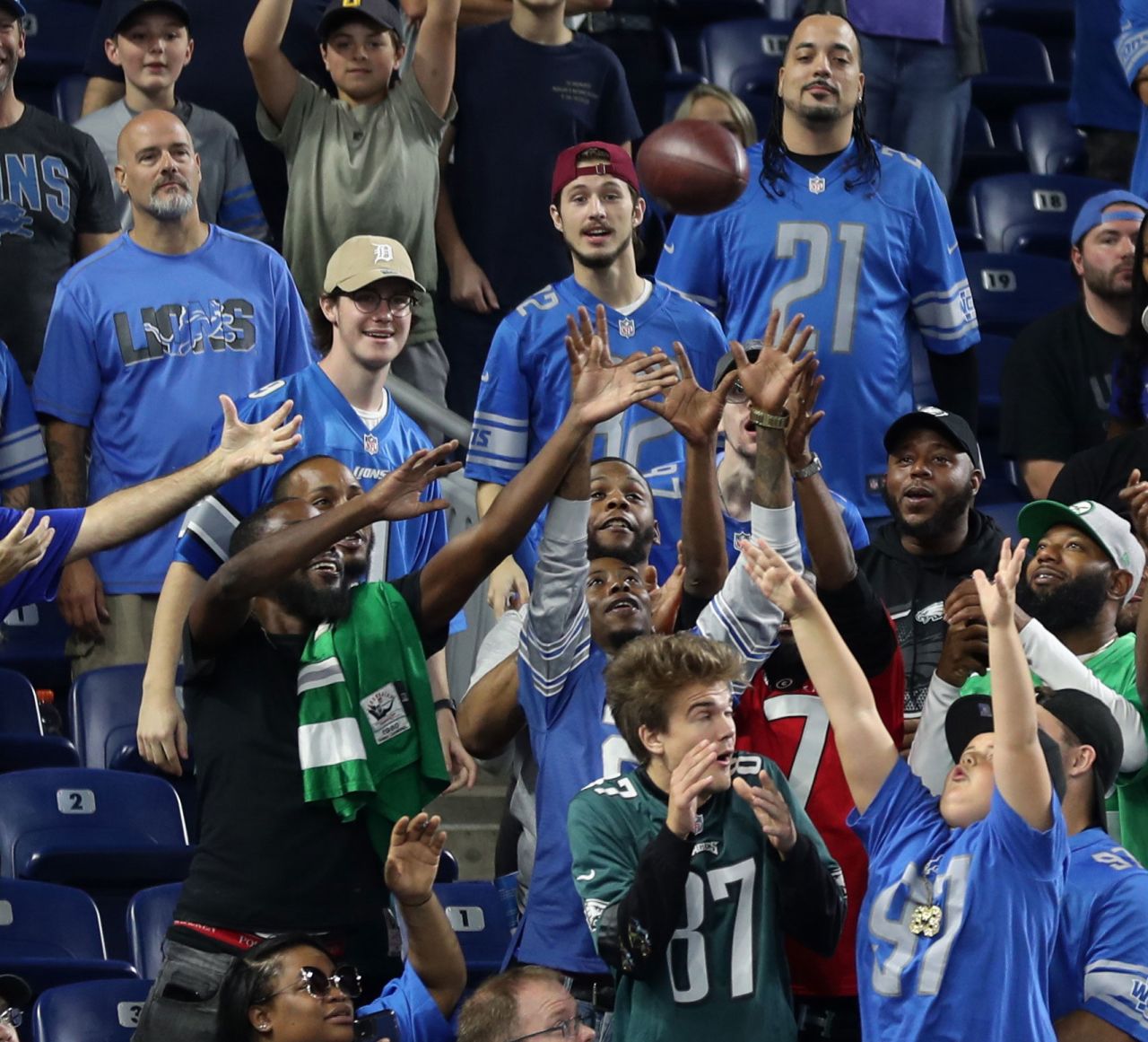 Detroit Lions fans play catch with running back Jamaal Williams at Ford Field. The Lions fell just short in a late comeback against the Philadelphia Eagles — scoring 14 points in the 4th quarter — to lose 38-35.