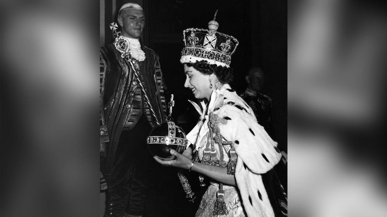 Queen Elizabeth II wearing the Imperial State Crown and carrying the Orb and scepter after her coronation.