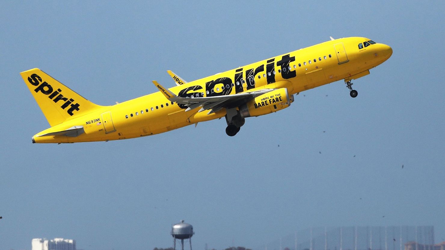A Spirit Airlines Airbus A320-232 takes off at the Orlando International Airport in November 2020. The budget airline is weighing competing takeover offers from JetBlue Airways of New York and Frontier Airlines of Denver. A sale to either will have an impact on employees, local facilities and the traveling public. (