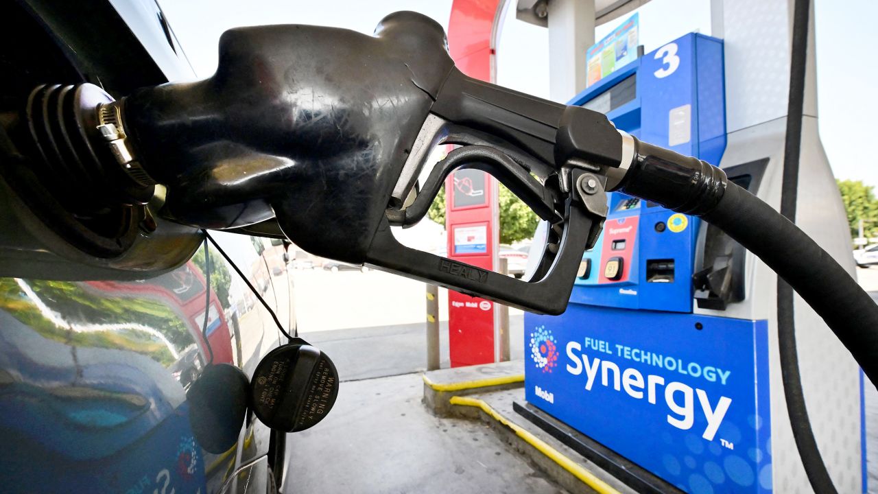 A gasoline nozzle pumps gas into a vehicle in Los Angeles on August 23, 2022.