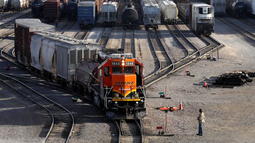 FILE- A BNSF rail terminal worker monitors the departure of a freight train, on June 15, 2021, in Galesburg, Ill. The major freight railroads say in a new report Thursday, Sept. 8, 2022, designed to put pressure on unions and Congress, that a strike would cost the economy more than $2 billion a day and disrupt deliveries of all kinds of goods and passenger traffic nationwide if it happens after a key deadline passes next week without a contract agreement. (AP Photo/Shafkat Anowar, File)