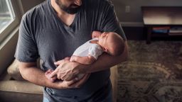 High angle view father carrying son while standing at home