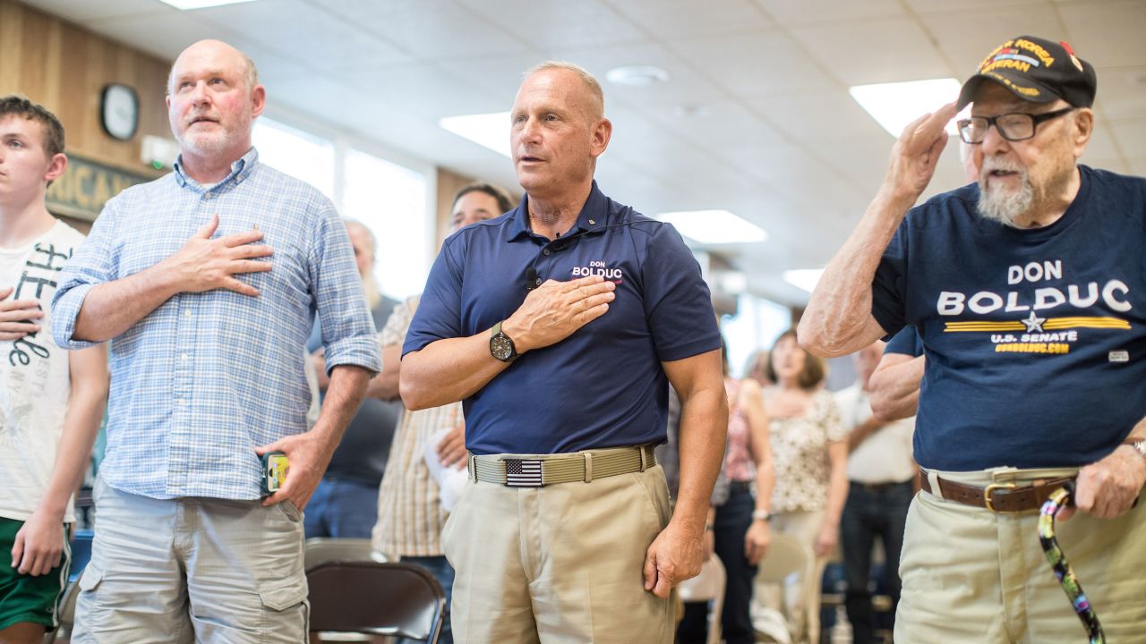 Republican Senate candidate Don Bolduc, center, with supporters at a town hall event during the Pledge of Allegiance on September 10, 2022 in Laconia, New Hampshire.