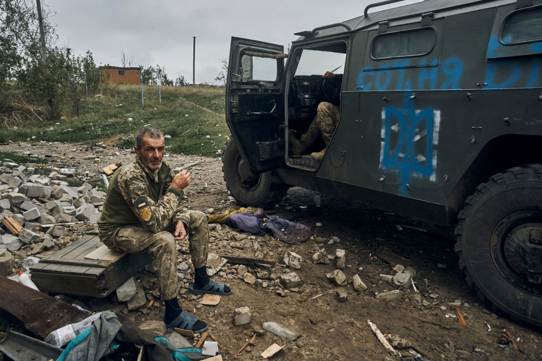A Ukrainian soldier takes a break to rest in the freed territory in the Kharkiv region, Ukraine, on Monday.