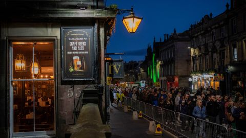 People line up to see the coffin of Queen Elizabeth II as she lies at rest at St. Giles' Cathedral in Edinburgh, Scotland.