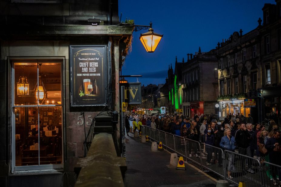 People line up to see the Queen's coffin as she lies at rest at the St. Giles' Cathedral.