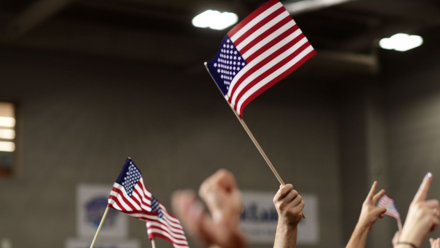 Supporters wave American flags before Democratic Pennsylvania Senate nominee John Fetterman holds a rally on September 11, 2022, at Montgomery County Community College in Blue Bell, Pennsylvania. 