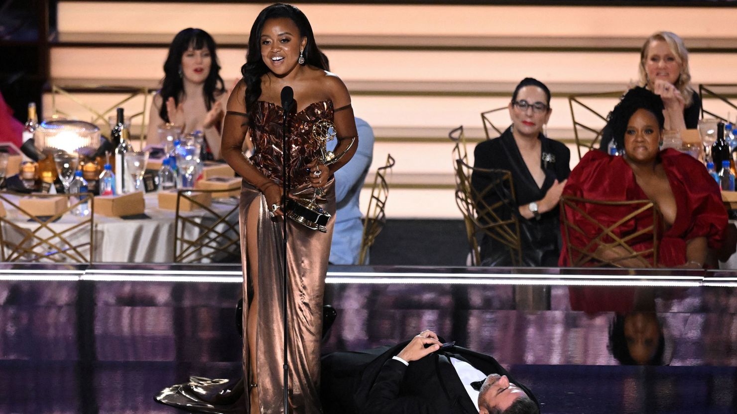 "Abbott Elementary" creator Quinta Brunson accepted the award for outstanding writing for a comedy series while Jimmy Kimmel was splayed underneath her, pretending to be unconscious. 
